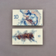 Illustration for article titled Gorgeous Banknotes Feature Flora, Fauna—And Skeletons Under UV Light